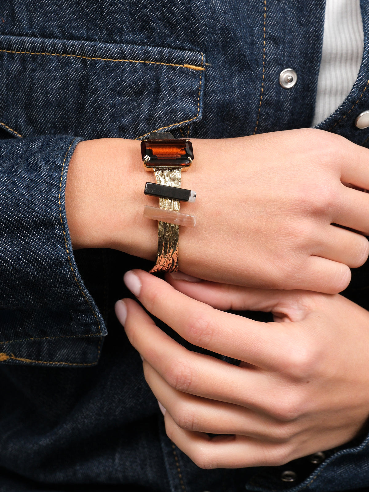 Rigid bangle bracelet with stones
